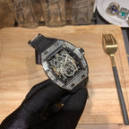 Richard Mille watch angled view, black rubber strap, diamond-like bezel, skeleton movement