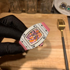 Richard Mille wristwatch with silver case and pink strap, tilted close-up of bezel and dial