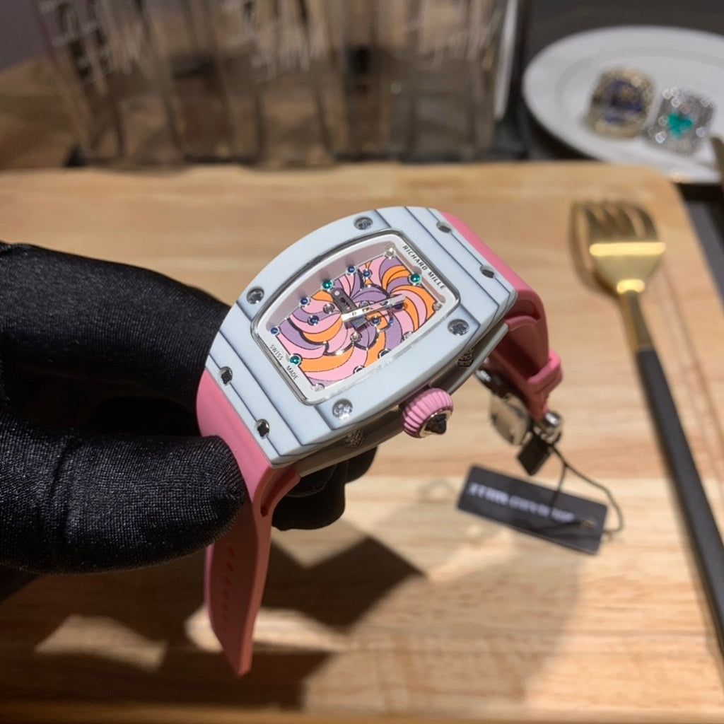 Richard Mille wristwatch with pink strap and silver case, side view showing colorful dial