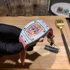 Richard Mille wristwatch with pink strap and silver case, side view showing colorful dial