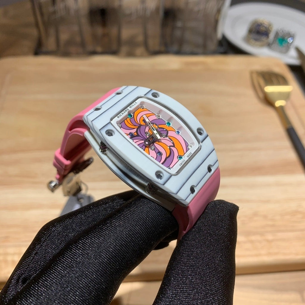 Richard Mille wristwatch profile: pink strap, silver case, colorful dial visible from the side