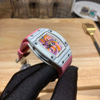 Richard Mille wristwatch profile: pink strap, silver case, colorful dial visible from the side