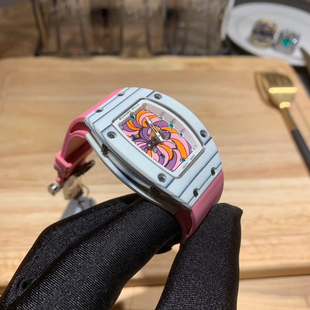 Richard Mille wristwatch profile: pink strap, silver case, colorful dial visible from the side
