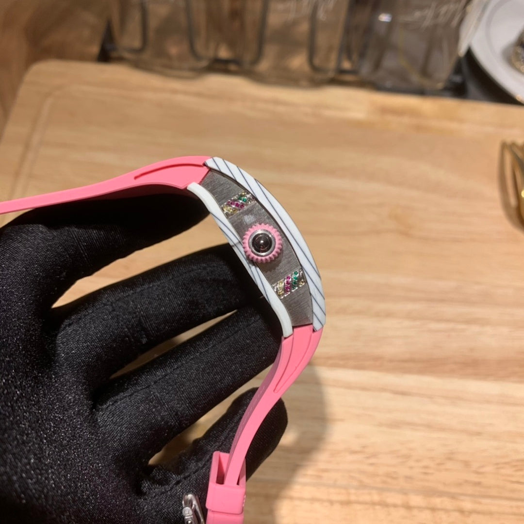 Richard Mille wristwatch side profile: pink case edge, silver crown area, intricate strap links