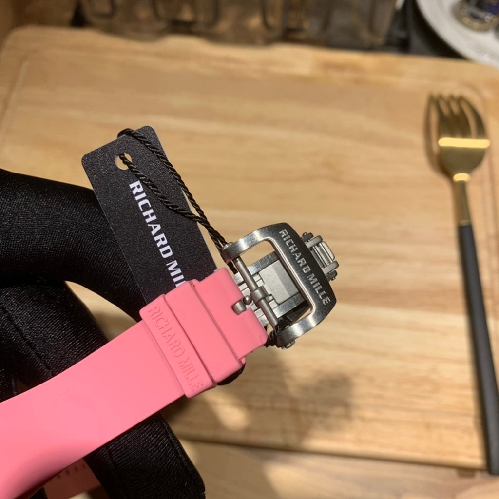 Richard Mille watch strap clasp view: pink rubber strap and silver buckle with markings