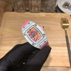 Richard Mille wristwatch with silver case and pink strap, angled view of colorful dial