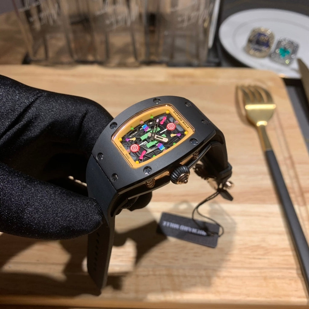 Black Richard Mille watch on black strap with multicolor dial, side profile