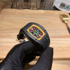 Black Richard Mille watch wrist view with multicolor dial and crown