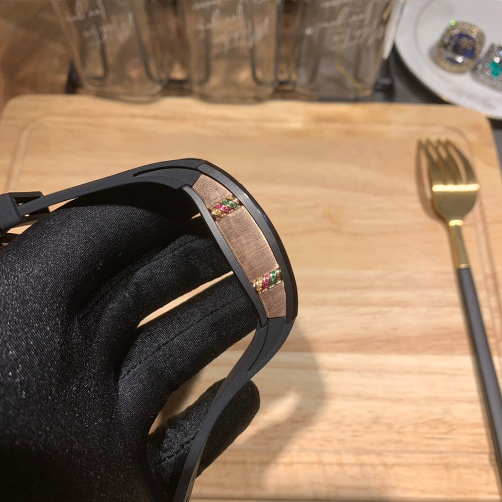 Black Richard Mille watch side view, multicolor dial window on rubber strap