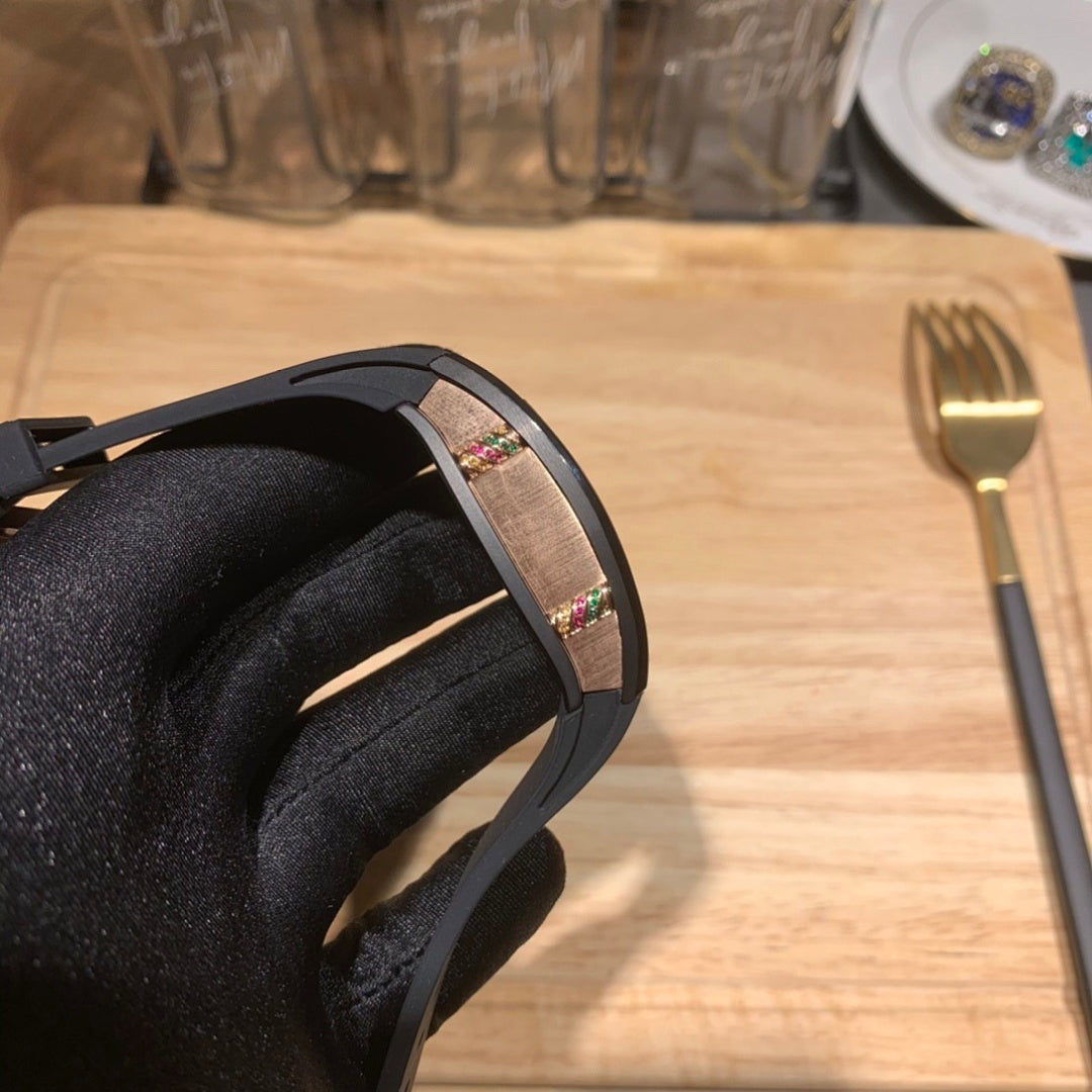 Black Richard Mille watch side view, multicolor dial window on rubber strap