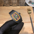 Black Richard Mille watch angled view, square bezel, multicolor skeleton dial
