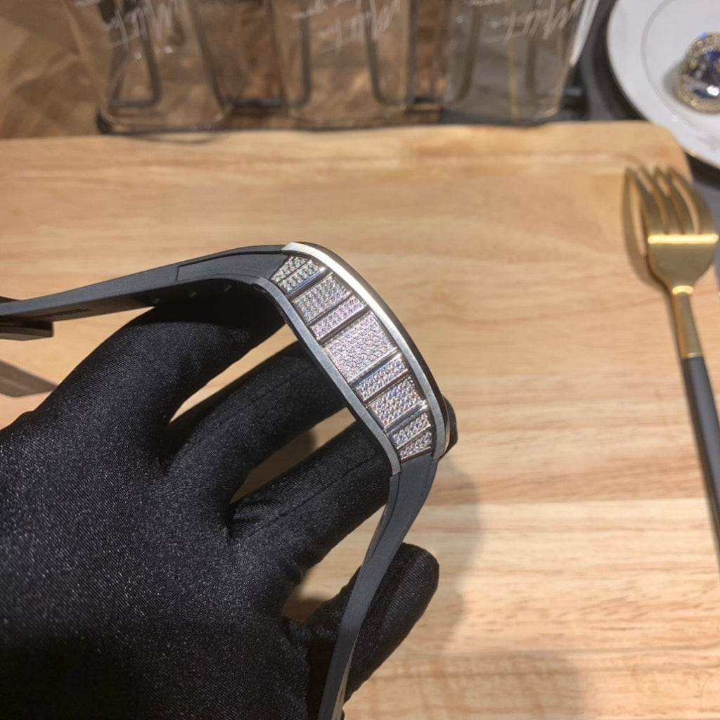 Richard Mille wristwatch profile view, black rubber strap with metal bezel detail