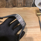 Richard Mille wristwatch profile view, black rubber strap with metal bezel detail
