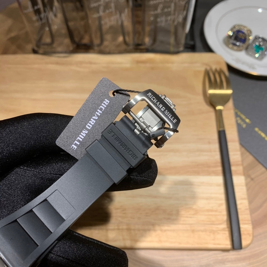 Richard Mille wristwatch clasp and strap attachment, black rubber band and metal hardware