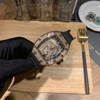 Jewelry skeleton watch with diamond bezel and black rubber strap on gloved hand