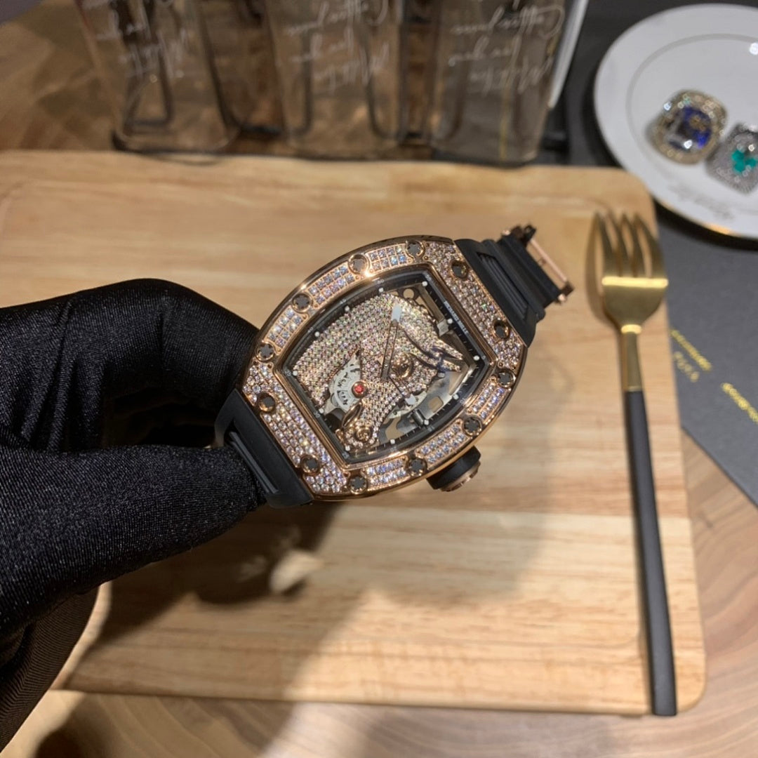 Jewelry skeleton watch with diamond bezel and black rubber strap on gloved hand
