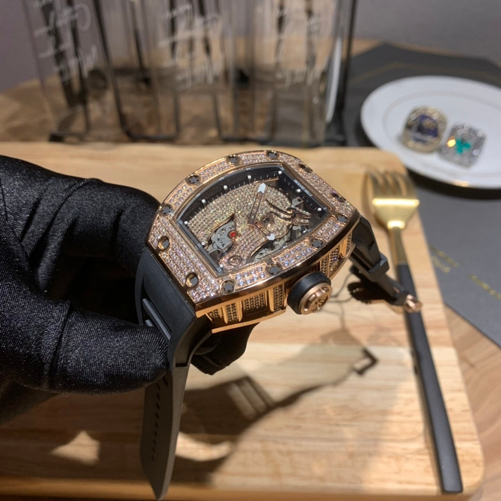 Skeleton watch on black rubber strap with diamond-set bezel and visible movement