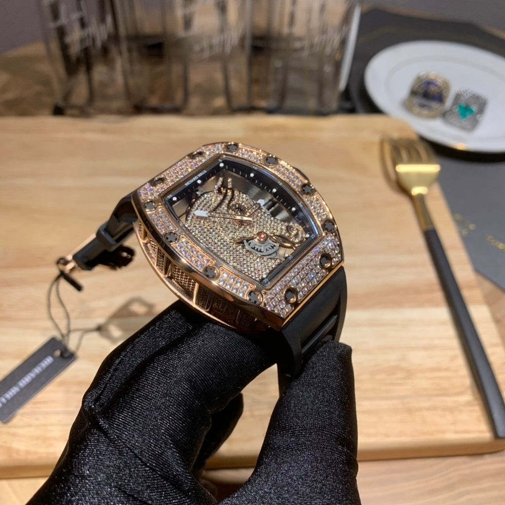 Openwork rectangular watch with diamond bezel and black rubber strap on display