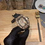 Luxury skeleton watch with black rubber strap, diamond-set case, openwork dial