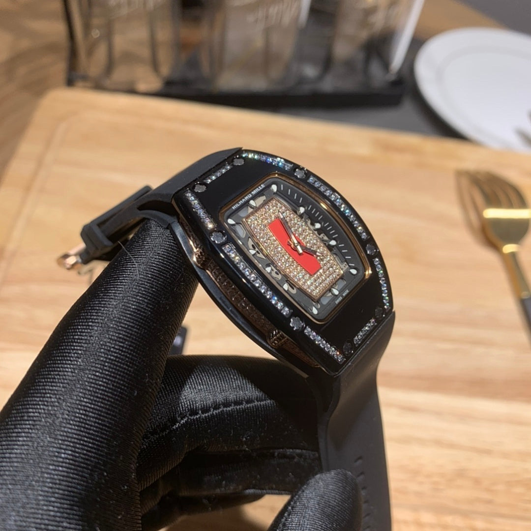 Richard Mille watch close-up on black rubber strap, blue dial with textured bezel