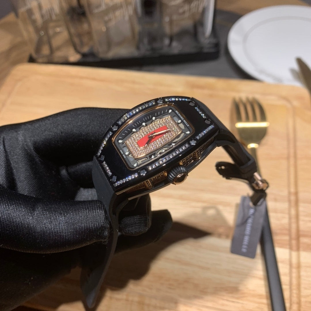 Richard Mille watch close-up on black rubber strap, red dial in jeweled case