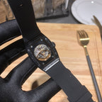 Richard Mille watch with black rubber strap, skeleton-style dial and metal accents
