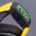 Black rubber strap with ridged texture and yellow accents, watch case edge and dial visible