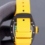 Yellow rubber watch strap with buckle and branding on the clasp area, black case back