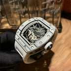 Close-up luxury wristwatch with silver case and visible mechanical skeleton dial