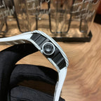 Side view of a white strap luxury wristwatch with textured metal link