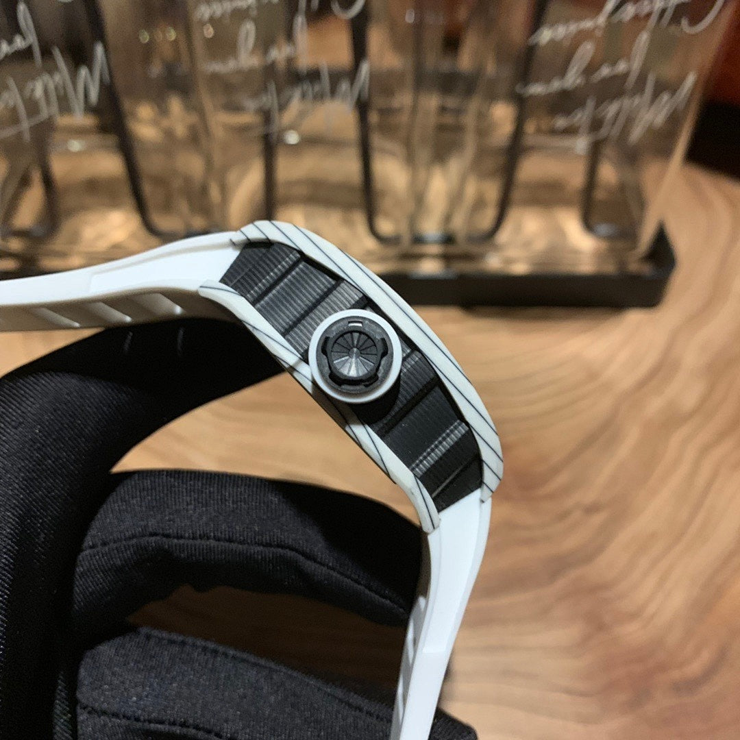 Side view of a white strap luxury wristwatch with textured metal link