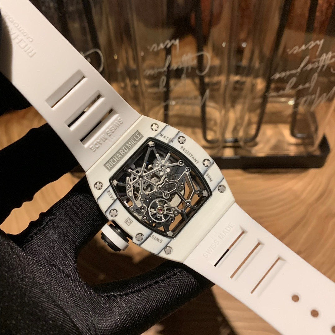 White strap luxury wristwatch with skeleton dial and silver-toned case