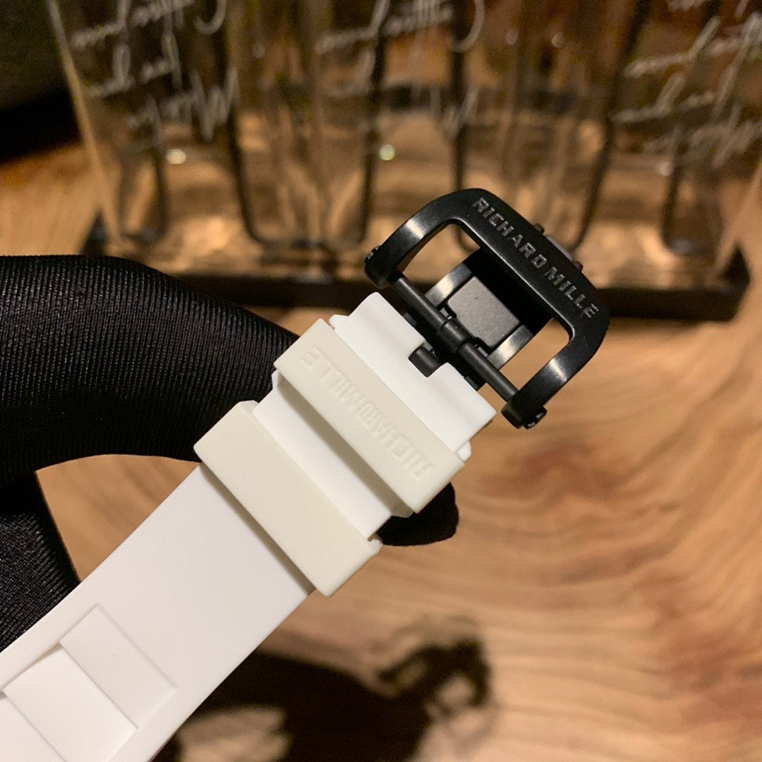 White rubber-style watch strap with black buckle and metal clasp