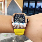 Richard Mille watch on wrist, rose-gold bezel detail, blue dial, yellow silicone strap