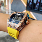 Richard Mille watch side view with rose-gold case, blue dial, yellow silicone strap