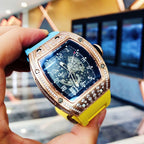 Richard Mille watch close-up with blue dial, gem-set bezel, yellow silicone strap
