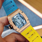 Richard Mille watch close-up with blue dial, rose-gold case, yellow silicone strap