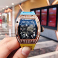 Richard Mille watch with rose-gold bezel, blue dial, and yellow silicone strap