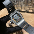 Luxury wristwatch case and strap with engraved markings and jeweled inner movement
