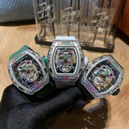 Luxury wristwatch set with three open-dial watches in green, yellow, and silver bezels
