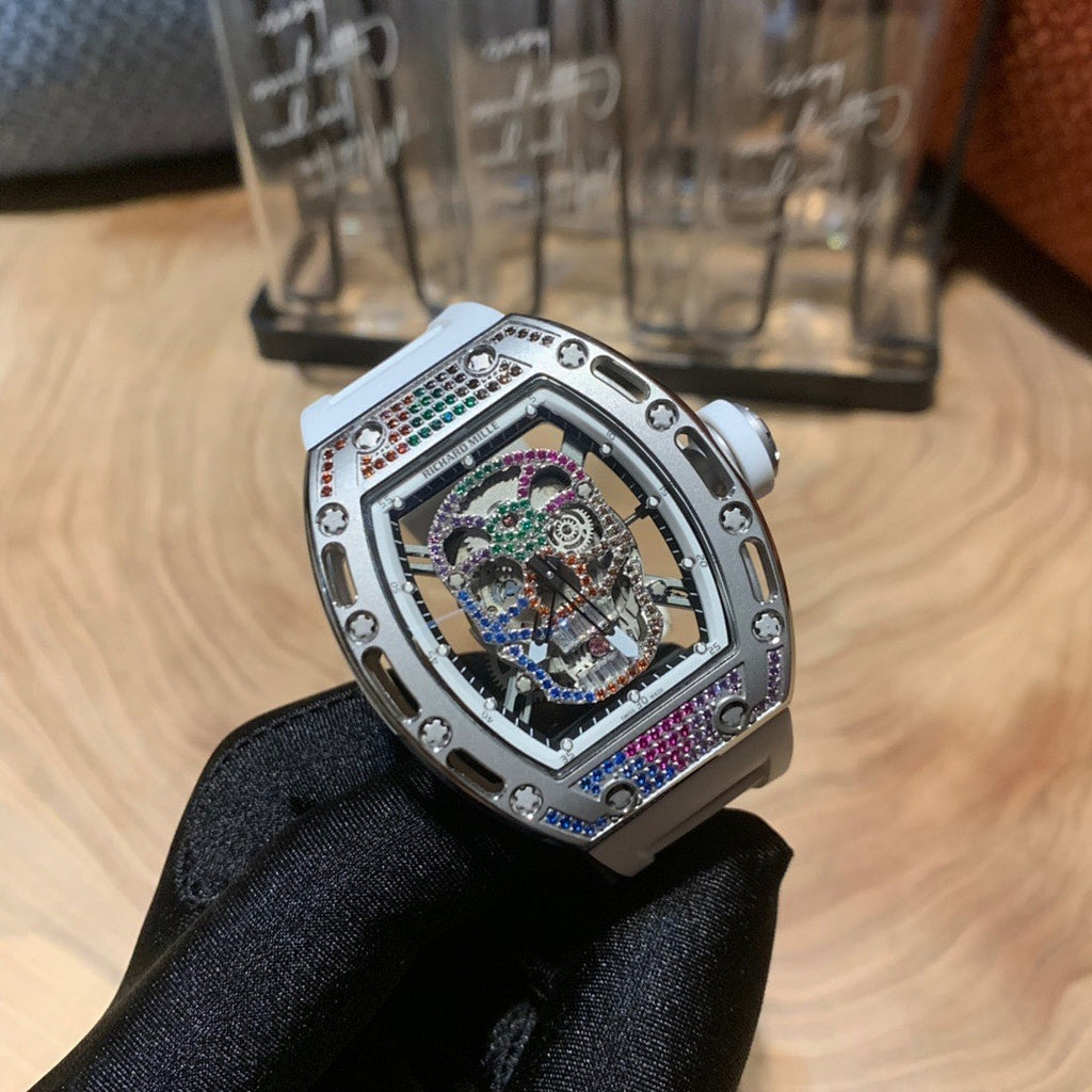 Luxury wristwatch with light silver case, jeweled open dial, and dark patterned strap