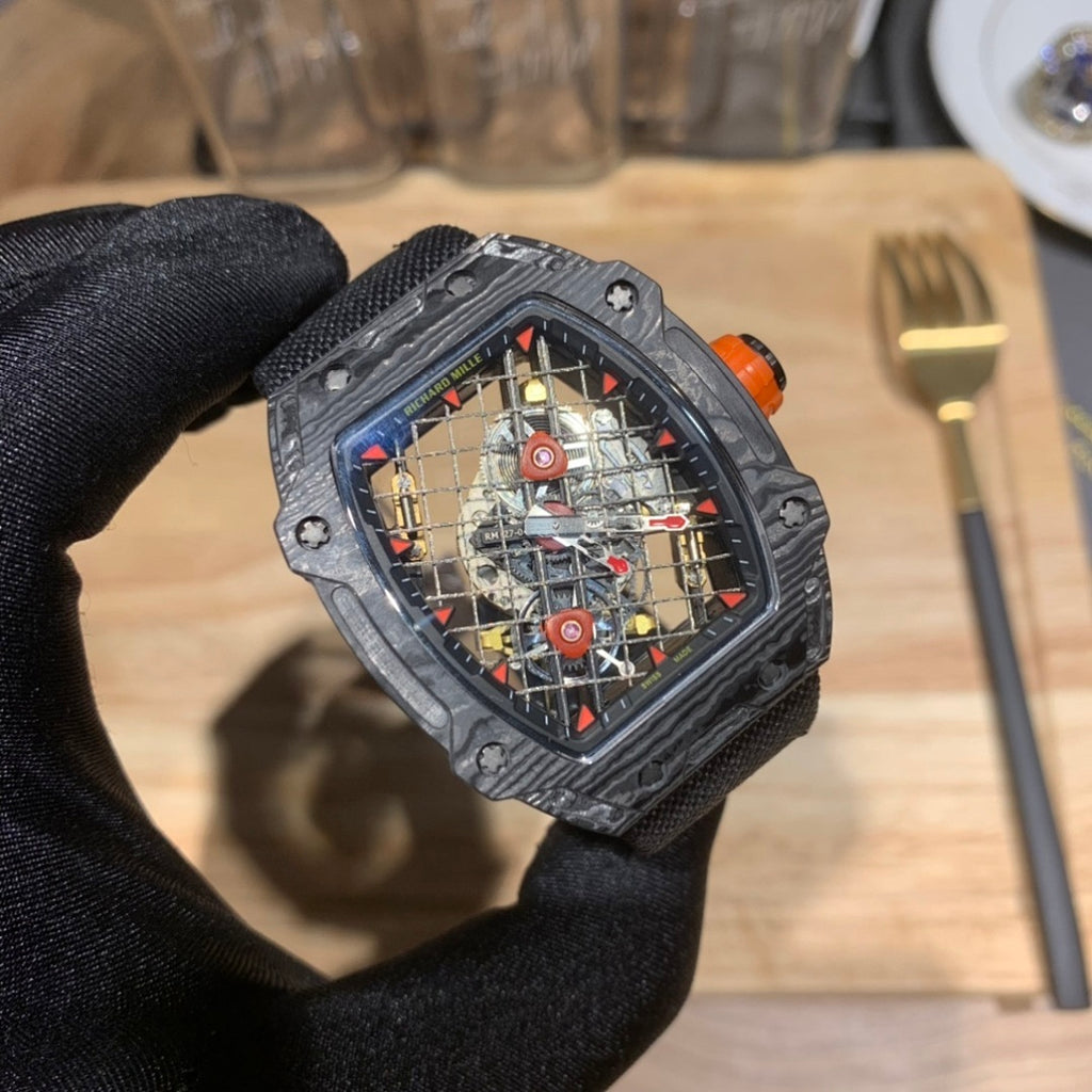 Richard Mille watch close-up with black case, orange crown, and colorful skeleton dial