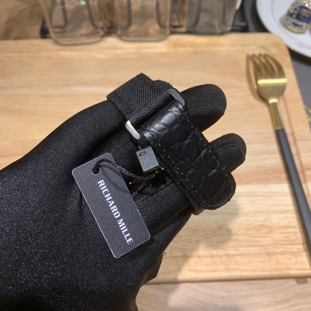 Richard Mille watch tag on black leather strap with metal clasp