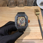 Richard Mille watch front view with black strap and square skeleton dial, red details