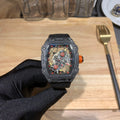 Richard Mille watch with black textured strap and square skeleton dial, red accents