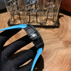 Richard Mille watch side profile with crown and black buckle, blue strap