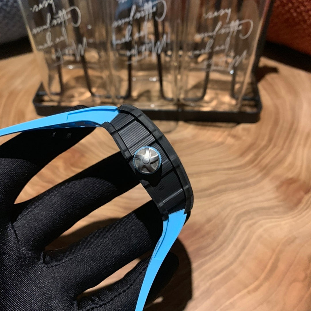 Richard Mille watch side profile with crown and black buckle, blue strap