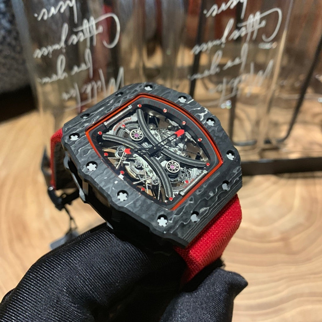 Richard Mille watch angled view, square skeleton dial in black case with red strap