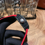 Richard Mille watch wrist strap side view, black rubber band with red edge and buckle