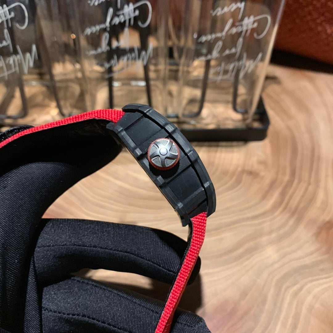 Richard Mille watch wrist strap side view, black rubber band with red edge and buckle